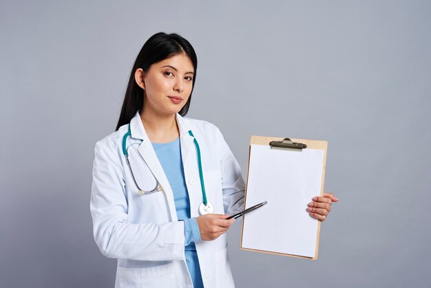 Photo doctor pointing on empty piece of paper