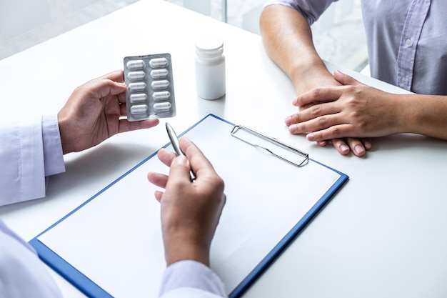 Doctor presenting with patient and checking results on report and prescription about the problem of illness and recommend using medicine healthcare and medical concept