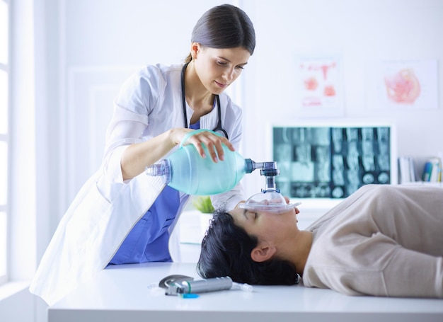 Doctor putting an oxygen mask in the hospital