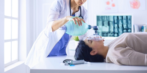 Doctor putting an oxygen mask in the hospital