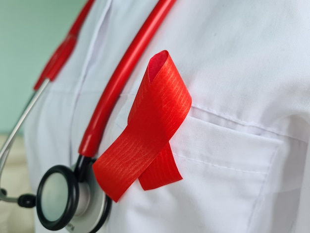 Doctor red ribbon symbol of the fight against HIV and AIDS