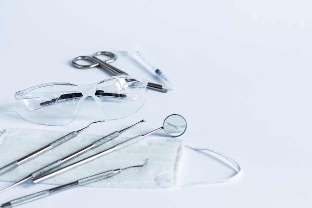 Doctor's dentistry tools for teeth dental care and treatment on white background