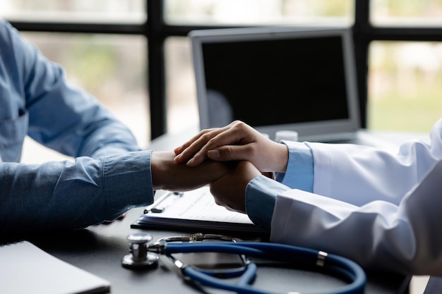 Doctor shook hands to encourage the patient after informing the results of the examination and informing the patients about treatment guidelines and prescribing medicines Disease examination concept