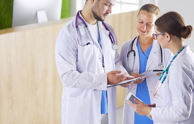 Doctor showing something in his tablet to his medical team