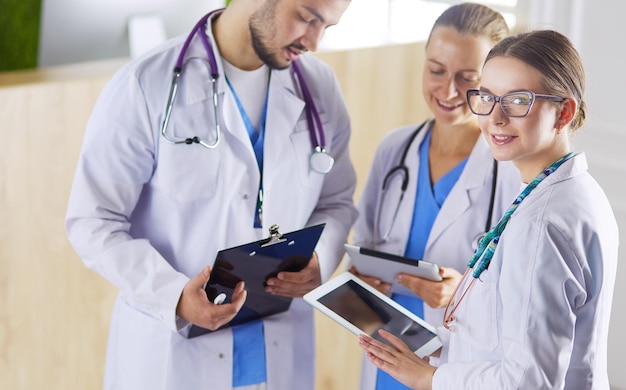 Doctor showing something in his tablet to his medical team