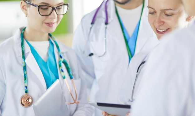 Doctor showing something in his tablet to his medical team