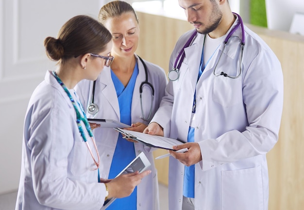 Doctor showing something in his tablet to his medical team