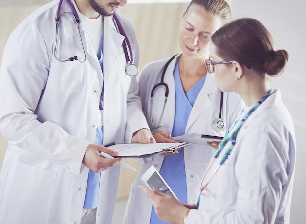 Doctor showing something in his tablet to his medical team