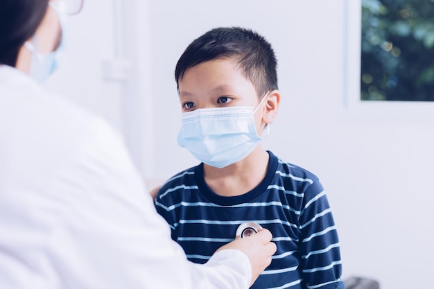 The doctor sits at work examining a child patient