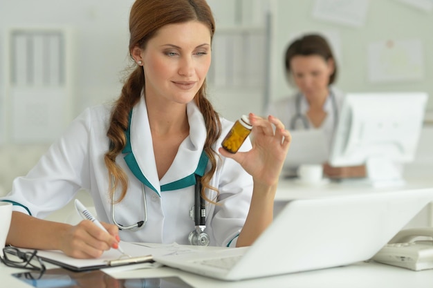 Doctor sitting at desk at work in hospital