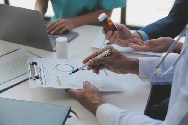 Doctor sitting at desk and writing a prescription for her patient