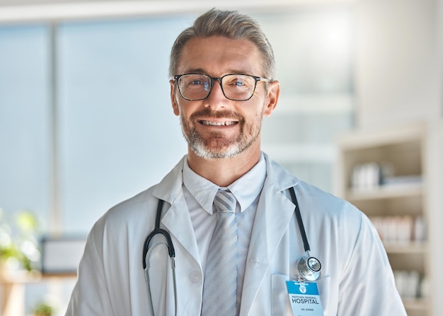 Doctor smile and office working at hospital clinic or medical facility Medic man and happy at work with stethoscope glasses and happiness on face in portrait at healthcare center in Atlanta