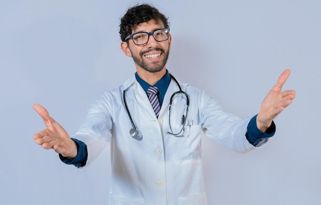 Doctor smiling with open arms welcoming Friendly doctor hugging the camera Medical friendship concept