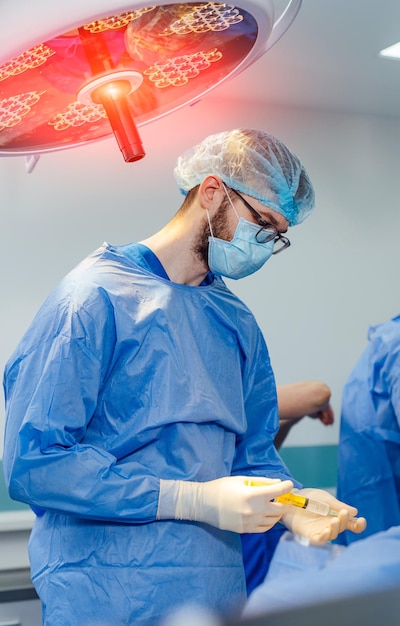 Doctor in sterile mask working in surgery hospital Emergency specialist in uniform