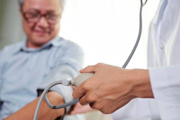 Doctor taking pulse of the patient