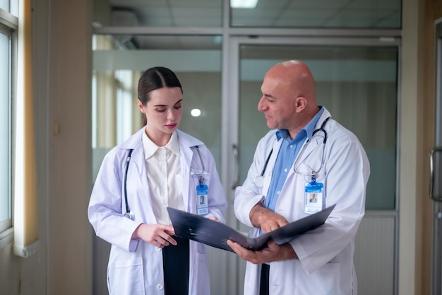 Doctor talking with woman doctor at hospital meeting room