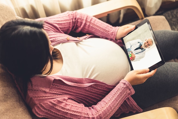 Doctor telemedicine service online video with pregnant woman for prenatal care