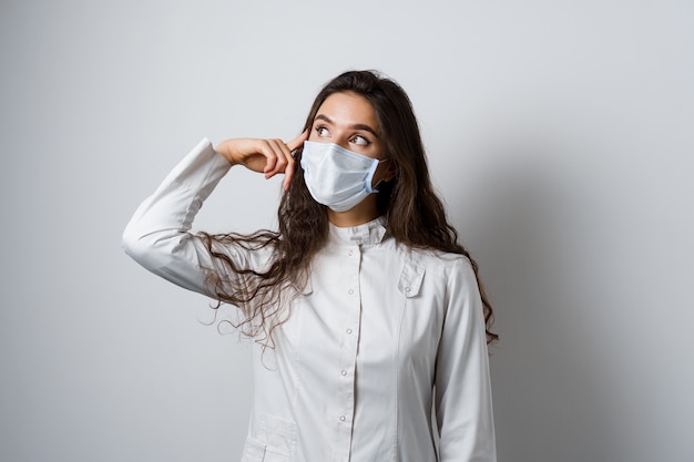 Doctor thinking about her hard work during quarantine covid-19. Working in medical clinic.