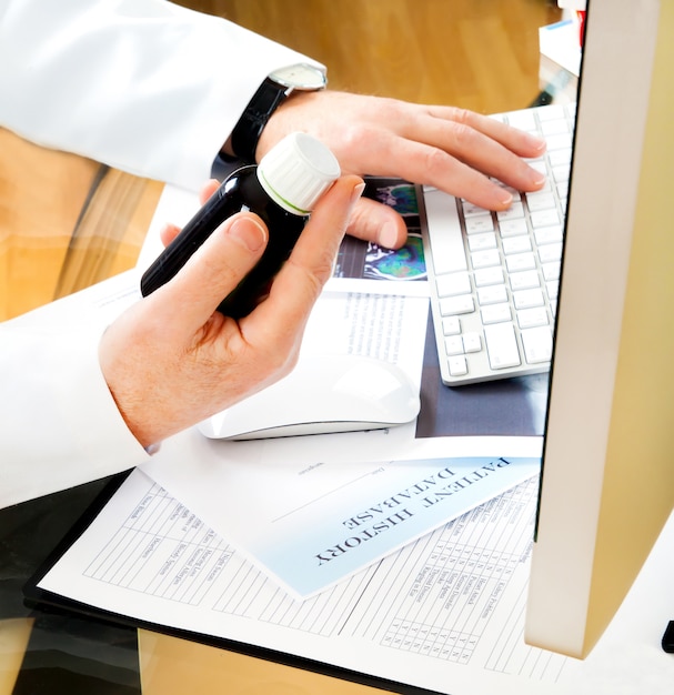 Doctor using a computer to prepare an online prescription