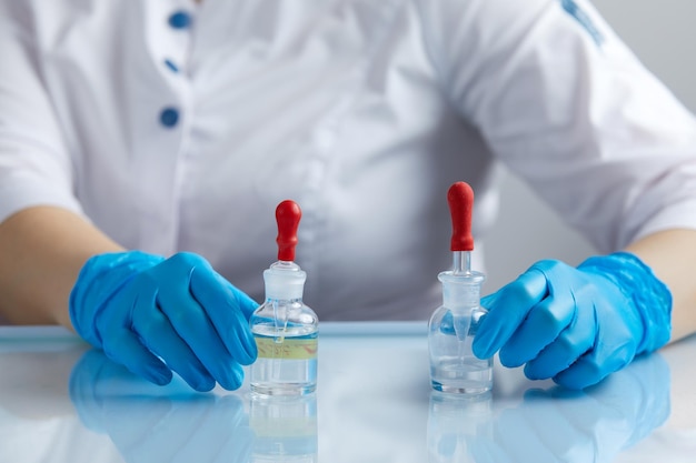 Doctor using pipette for taking samples for test in special chemical laboratory or clinic