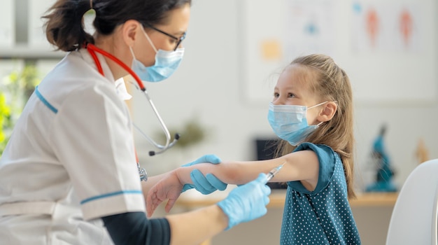 Doctor vaccinating child at hospital.