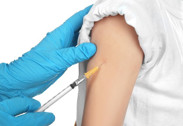 Doctor vaccinating child on white background closeup