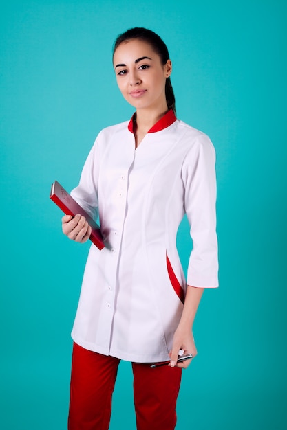 Doctor in a white coat holding a notebook