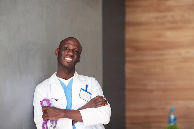 Doctor with arms folded in modern office Doctor