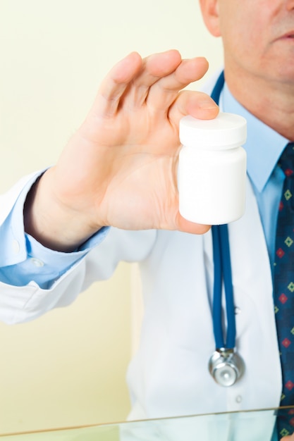 Doctor with capsules bottle hand