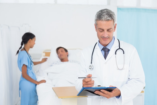 Doctor with colleagues and patient behind