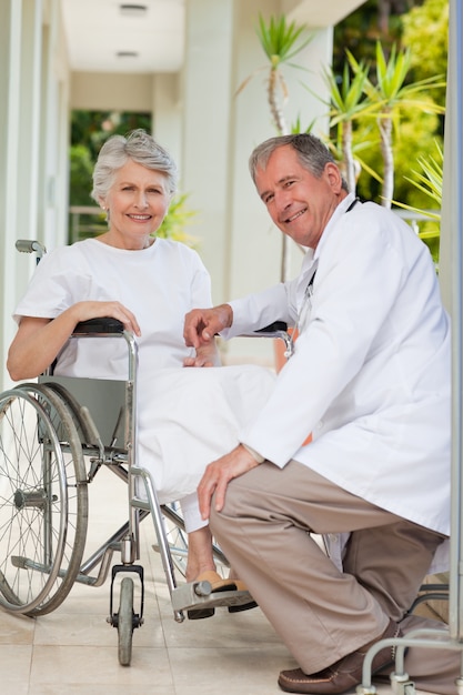 Doctor with his patient looking at the camera