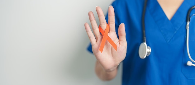 Photo doctor with orange ribbon for leukemia kidney cancer day world multiple sclerosis crps set