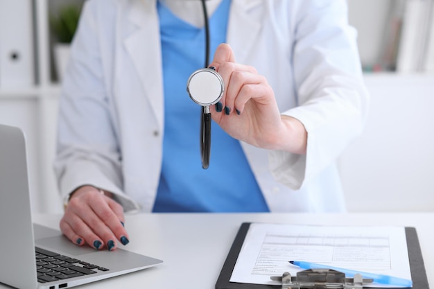 Doctor with a stethoscope in the hands.