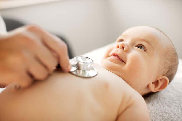 doctor with stethoscope listening to baby patient