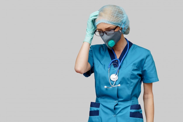 Doctor with stethoscope wearing protective mask and latex gloves