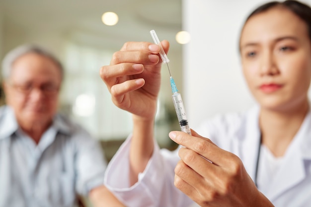 Doctor with syringe at hospital