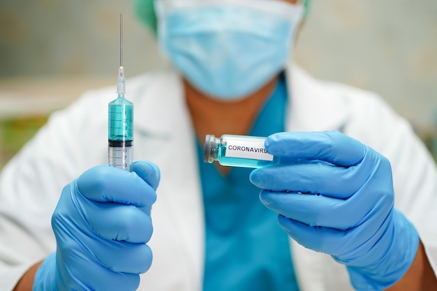 Doctor with vaccine and syringe