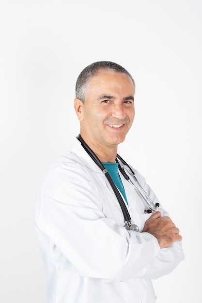 Doctor with white hair, and stethoscope smiling, white background