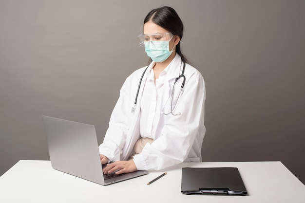 Doctor woman is analysis data on laptop computer