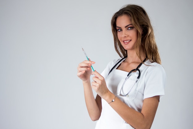 Doctor woman with syringe isolated on white , nurse with needle