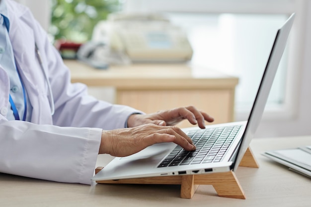 Doctor working on laptop at office