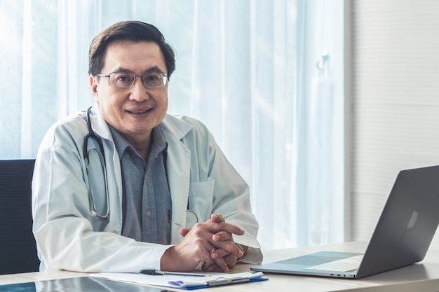 Doctor working with patient health data in the hospital office.