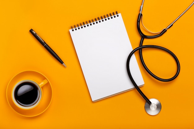 Doctor workspace with Medical equipment on yellow table with top view