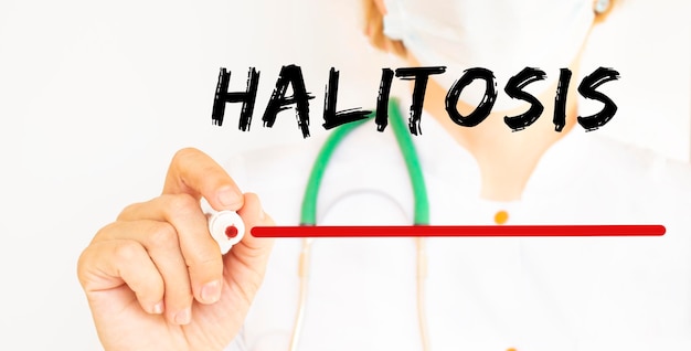 The doctor writes the text HALITOSIS with a marker Medical concept