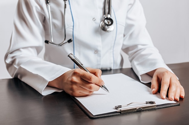 Doctor Writing Medical Pill Prescription for Patient