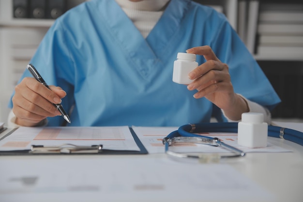 Doctor writing out RX prescription selective focus