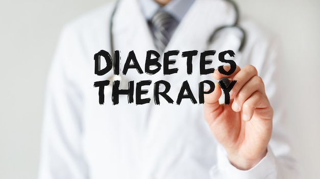 Doctor writing word Diabetes Therapy with marker, Medical concept