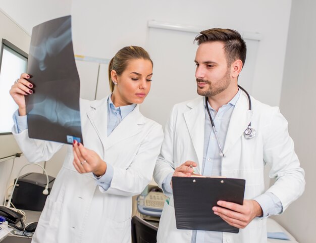 Doctors examining an x-ray of the patient at clinic