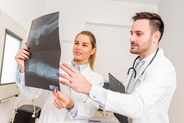 Doctors examining an x-ray of the patient at clinic