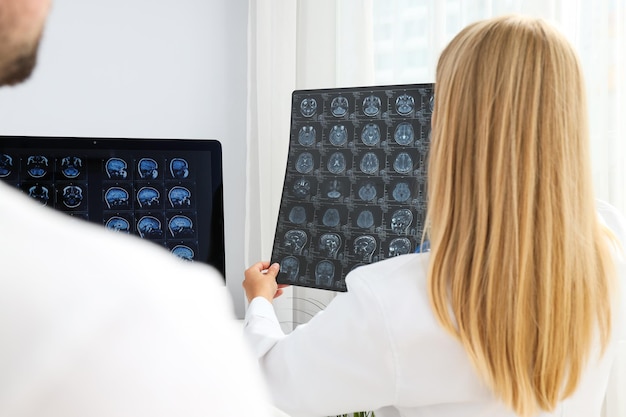 Doctors look at MRI images of a human head